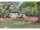 A serene backyard featuring a wooden deck and home exterior, ideal for outdoor enjoyment at 3293 River Rd, Johns Island, SC 29455