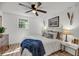Bright bedroom with hardwood floors, ceiling fan, and comfortable bedding at 3293 River Rd, Johns Island, SC 29455