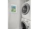 The laundry area showcases a stacked washer and dryer setup, accompanied by a view from the window at 3293 River Rd, Johns Island, SC 29455