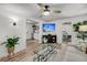 Cozy living room features a ceiling fan, modern decor, and a view into the kitchen at 3293 River Rd, Johns Island, SC 29455