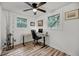 Bright office with wood-look flooring, ceiling fan, and desk near two windows bringing in natural light at 3293 River Rd, Johns Island, SC 29455