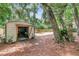 Open shed for storing your gardening tools, complemented by a large yard and mature trees at 3293 River Rd, Johns Island, SC 29455