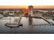 Aerial view of the property and adjacent harbor with yachts and surrounding city buildings during a beautiful sunset at 330 Concord St # 2F, Charleston, SC 29401