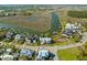 Stunning aerial view of a waterfront community with houses, marsh, and a winding river at 332 Bayley Rd, Daniel Island, SC 29492
