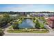 Aerial view of a city center, featuring a scenic pond, beautiful landscaping, and various commercial and residential buildings at 332 Bayley Rd, Daniel Island, SC 29492