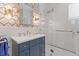 Beautiful bathroom with a glass shower, stylish blue vanity, and decorative wallpaper at 332 Bayley Rd, Daniel Island, SC 29492