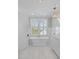 Luxurious bathroom featuring a freestanding tub, shuttered window, and elegant fixtures at 332 Bayley Rd, Daniel Island, SC 29492
