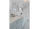 Elegant bathroom featuring a modern vanity with a round mirror, stylish fixtures, and patterned tile floor at 332 Bayley Rd, Daniel Island, SC 29492