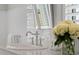 A close view of this bathroom vanity shows a clean faucet and flowers at 332 Bayley Rd, Daniel Island, SC 29492