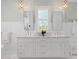 A spacious bathroom with a double vanity, pendant lights, and a large window at 332 Bayley Rd, Daniel Island, SC 29492
