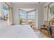Bright bedroom with large windows, providing beautiful views of the surrounding nature and waterfront at 332 Bayley Rd, Daniel Island, SC 29492