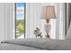 Close up view of the table lamp, window, and bed in the bedroom at 332 Bayley Rd, Daniel Island, SC 29492