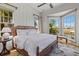 Serene bedroom with a large bed, bay window, and peaceful views of the waterfront at 332 Bayley Rd, Daniel Island, SC 29492