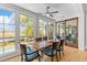 Stylish dining area with a unique wood table, comfortable blue chairs, and bright windows overlooking the scenic outdoors at 332 Bayley Rd, Daniel Island, SC 29492