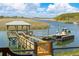 Dock featuring a boat lift, gazebo with seating, and beautiful views of the water at 332 Bayley Rd, Daniel Island, SC 29492