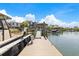 Long wooden dock featuring boat lifts and a gazebo, with beautiful views of the water and surrounding neighborhood at 332 Bayley Rd, Daniel Island, SC 29492