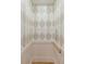 A residential elevator with patterned wallpaper and a wooden handrail is seen here at 332 Bayley Rd, Daniel Island, SC 29492