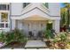 Quaint front porch with chairs and lovely rose bushes, creating a welcoming entrance at 332 Bayley Rd, Daniel Island, SC 29492