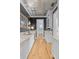 Hallway bar featuring granite countertops, a wine fridge, light wood floors, and detailed millwork at 332 Bayley Rd, Daniel Island, SC 29492