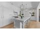 Bright open kitchen with white cabinetry, stylish pendant lighting, a large island, and stainless steel appliances at 332 Bayley Rd, Daniel Island, SC 29492