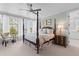 This main bedroom has a ceiling fan and water views from a window at 332 Bayley Rd, Daniel Island, SC 29492