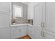 Bright pantry features ample white cabinetry, white countertops, decorative wallpaper, and window for natural light at 332 Bayley Rd, Daniel Island, SC 29492