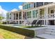 Back exterior of home featuring a pool, lush lawn, outdoor seating, and exterior balconies at 332 Bayley Rd, Daniel Island, SC 29492