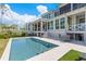 Back exterior of home featuring a pool, lush lawn, and outdoor seating at 332 Bayley Rd, Daniel Island, SC 29492