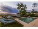 Inviting backyard pool with lounge chairs and stunning river views, perfect for relaxation at 332 Bayley Rd, Daniel Island, SC 29492