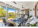 Comfortable screened porch features views of the water, ample seating, ceiling fans, and an outdoor rug at 332 Bayley Rd, Daniel Island, SC 29492