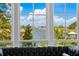 Serene water view framed by large windows and a plush leather couch, offering a cozy and picturesque setting at 332 Bayley Rd, Daniel Island, SC 29492
