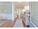 Bright entryway features hardwood floors, soft blue walls, and decorative lighting leading to an open-concept living space at 3585 Sawlog Dr, Summerville, SC 29486