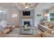 Cozy living room features a fireplace, coffered ceiling, recessed lighting, and plenty of natural light at 3585 Sawlog Dr, Summerville, SC 29486