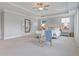 Large main bedroom boasts soft gray walls, tray ceiling, plush carpeting, sitting area and plenty of natural light at 3585 Sawlog Dr, Summerville, SC 29486