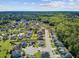 A beautiful aerial view showcases a neighborhood with a pond and lush greenery next to a dense forest under a partly cloudy sky at 3801 Canary Ct, North Charleston, SC 29420