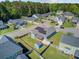 Aerial view of a single-Gathering home featuring a well-manicured lawn and solar panels at 3801 Canary Ct, North Charleston, SC 29420