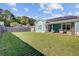 Lush, green backyard with fenced perimeter and solar panels on roof at 3801 Canary Ct, North Charleston, SC 29420