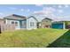 Expansive green backyard with a shed, patio, and well-maintained lawn at 3801 Canary Ct, North Charleston, SC 29420