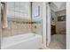 This bathroom shows a tub with beige tiling and an open doorway at 3801 Canary Ct, North Charleston, SC 29420