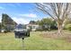 Community grill area with view of neighborhood homes and pool in distance at 3801 Canary Ct, North Charleston, SC 29420