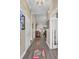Long hallway showcasing wood flooring and white trim, leading to an open living space at 3801 Canary Ct, North Charleston, SC 29420