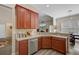 Well-lit kitchen with wood cabinets, granite countertops, and stainless steel appliances at 3801 Canary Ct, North Charleston, SC 29420