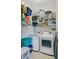 Well-organized laundry room with white washer and dryer, wire shelving, and tile floors at 3801 Canary Ct, North Charleston, SC 29420
