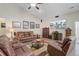 Comfortable living room with leather sofas, a ceiling fan, and a large television for entertainment at 3801 Canary Ct, North Charleston, SC 29420