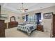 Serene main bedroom featuring a ceiling fan, tray ceiling, and coordinated decor at 3801 Canary Ct, North Charleston, SC 29420