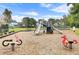 Community playground area with slides, spring riders, and benches at 3801 Canary Ct, North Charleston, SC 29420