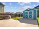 Backyard with a turquoise shed, large concrete patio, and wood privacy fence at 3801 Canary Ct, North Charleston, SC 29420