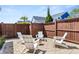 Cozy backyard area with Adirondack chairs and a gravel base, perfect for outdoor relaxation and gatherings at 383 Oak Park St, Summerville, SC 29486