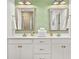 Double vanity bathroom with modern finishes, dual mirrors, and decorative wall covering at 383 Oak Park St, Summerville, SC 29486