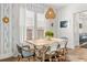 Stylish dining room with an eye-catching chandelier, chic wallpaper, and comfortable seating for six at 383 Oak Park St, Summerville, SC 29486